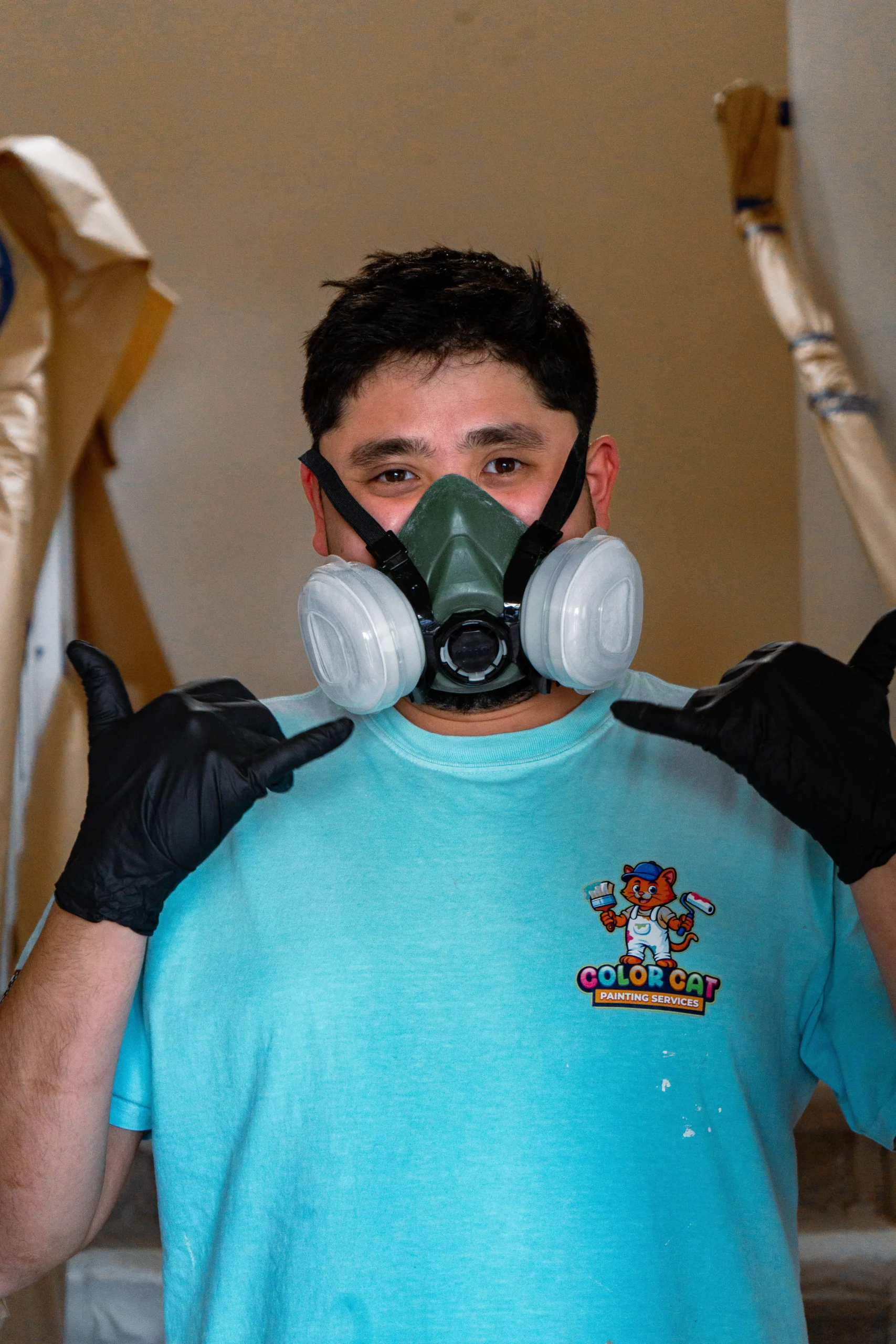 Professional Painter with Safety Gear A painter wearing a respirator mask and gloves, ready for safe and professional painting in Washington.